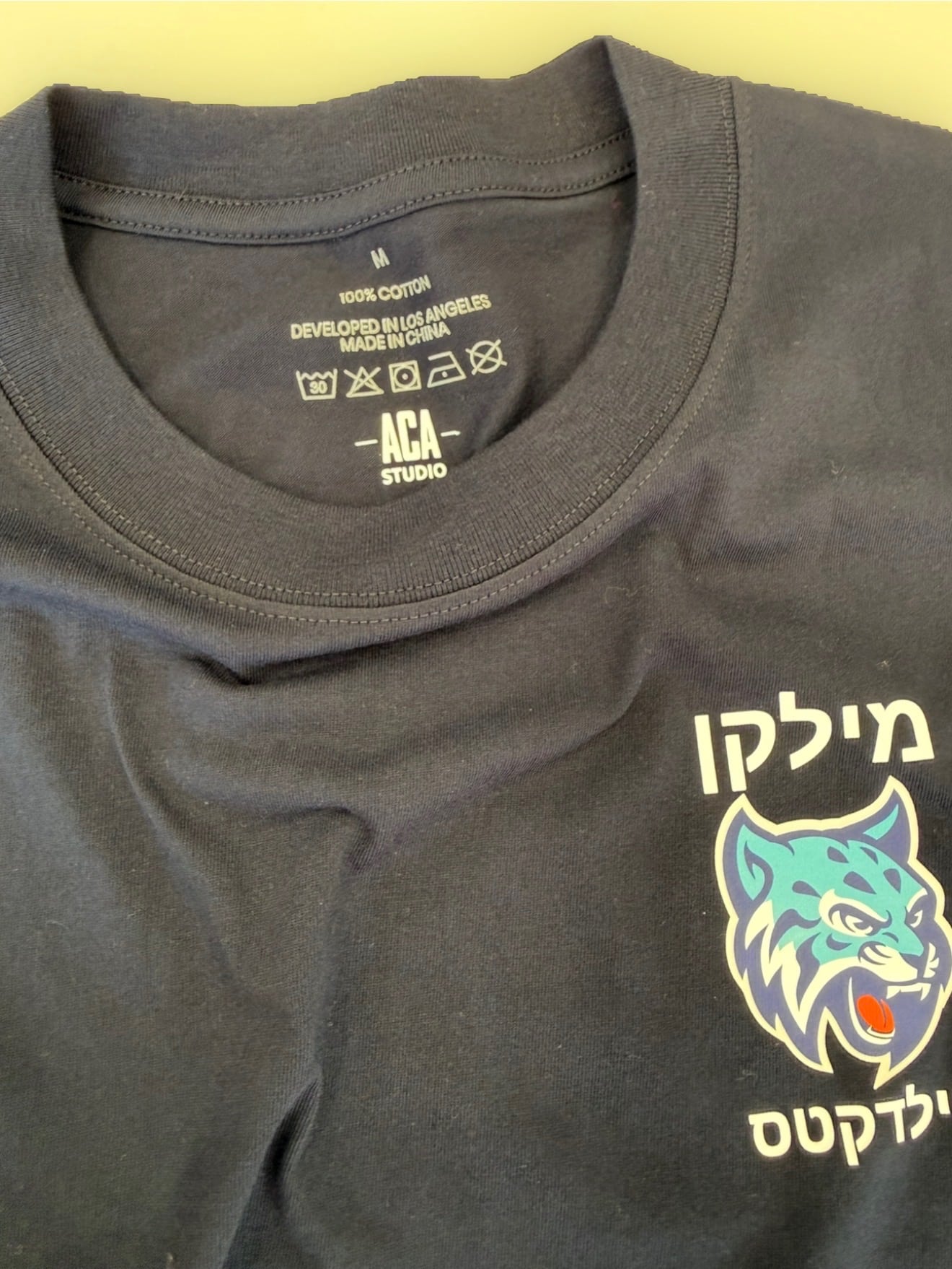 Black ACA Studio custom team T-shirt with mascot artwork