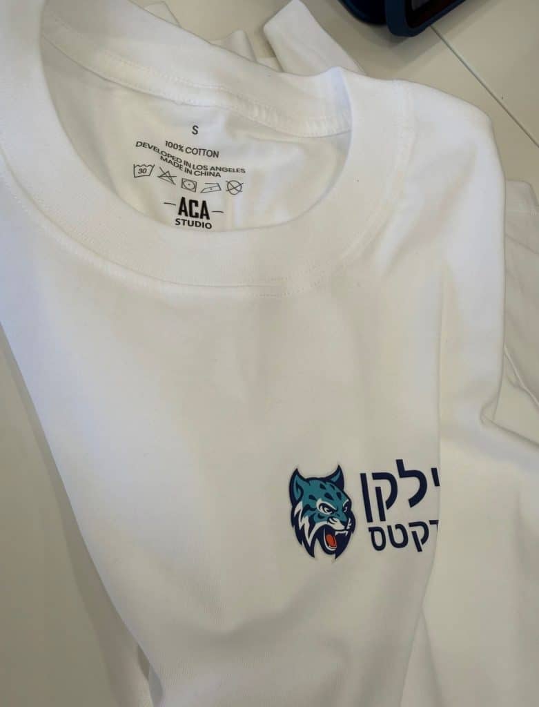 White ACA Studio custom team T-shirt with mascot artwork