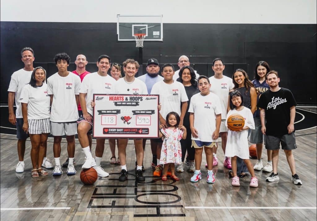 Hearts and Hoops fundraiser group holding Every Shot Saves Lives sign