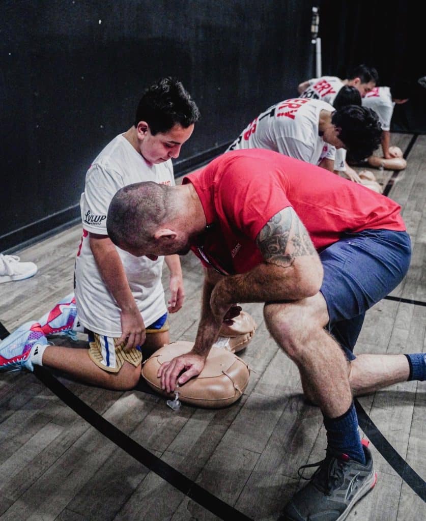Hearts and Hoops attendees learning CPR during fundraiser