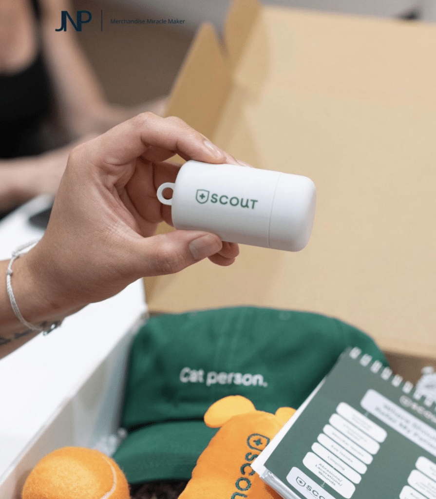 White Scout-branded accessory case displayed above the merchandise kit