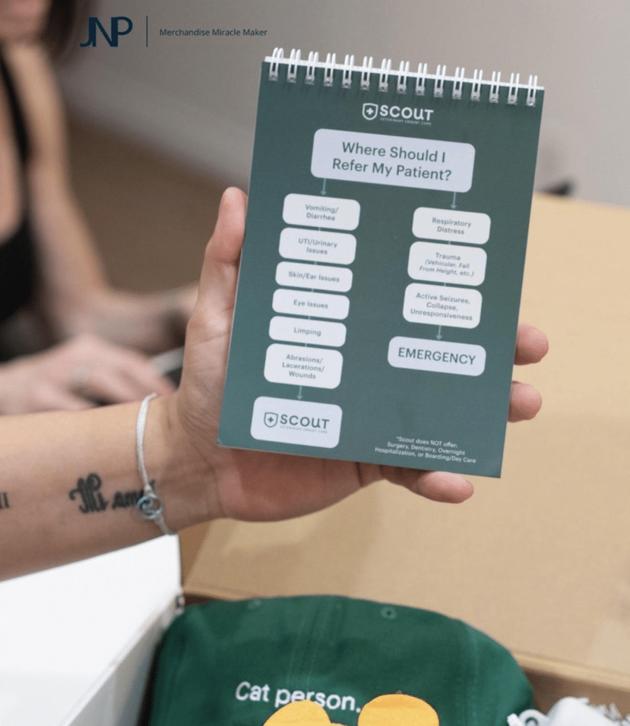 Scout-branded spiral-bound referral guide with a green cap in the merchandise kit