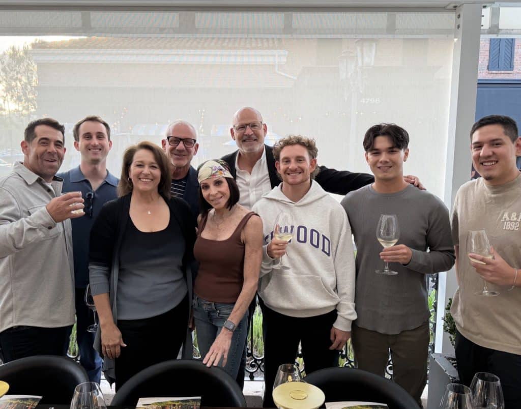 JNP teammates posing together with wine glasses at the Q4 kickoff